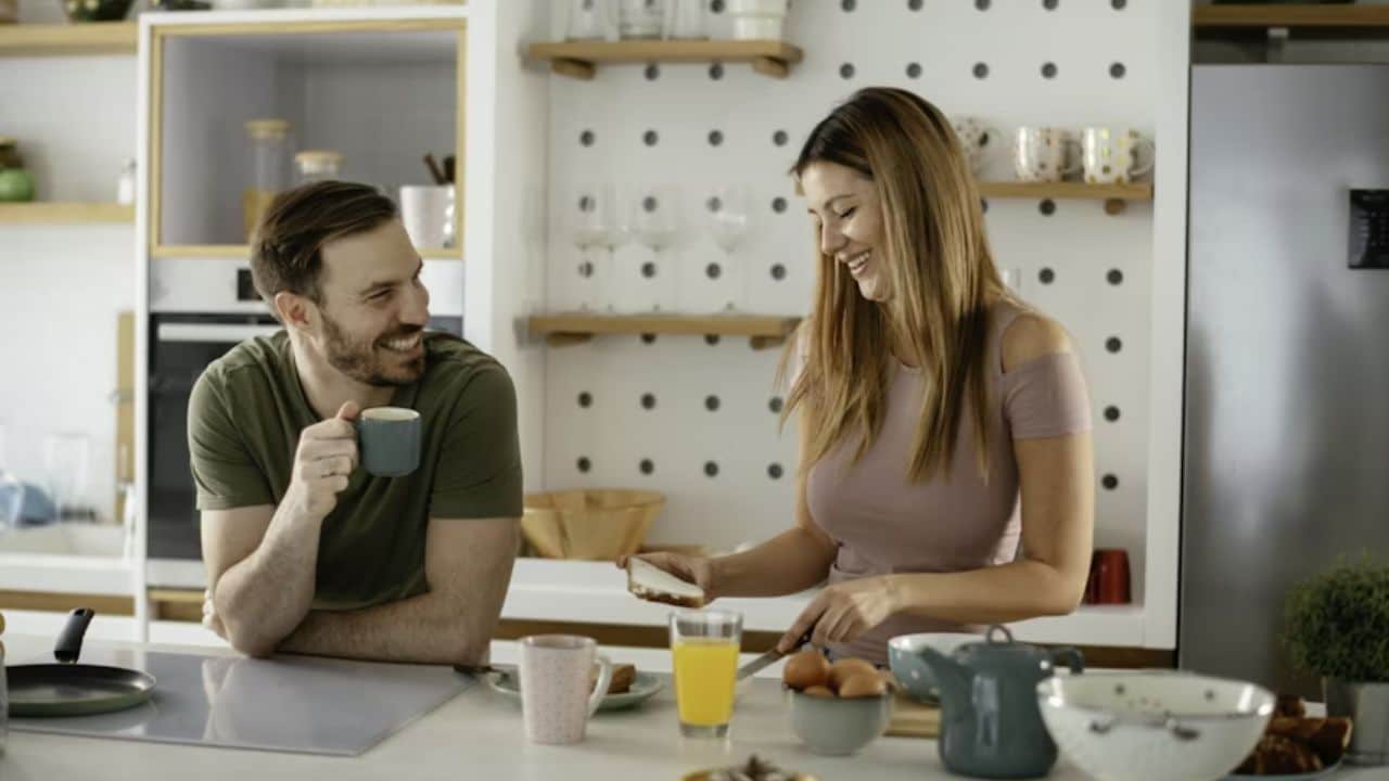 Man attentively listening to partner talk over breakfast.
