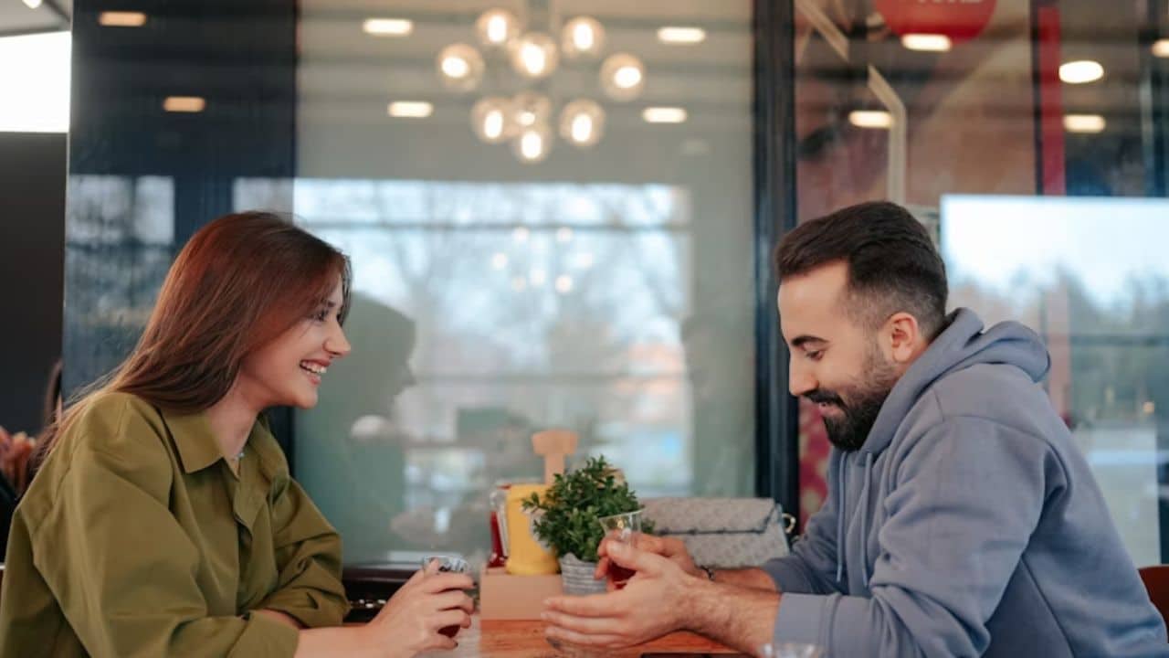 ALT Text: Man sharing a personal story with partner during a quiet moment.