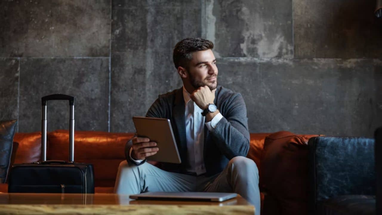 Man thinking and working on a self help app on a tablet after a relationship breakthrough.