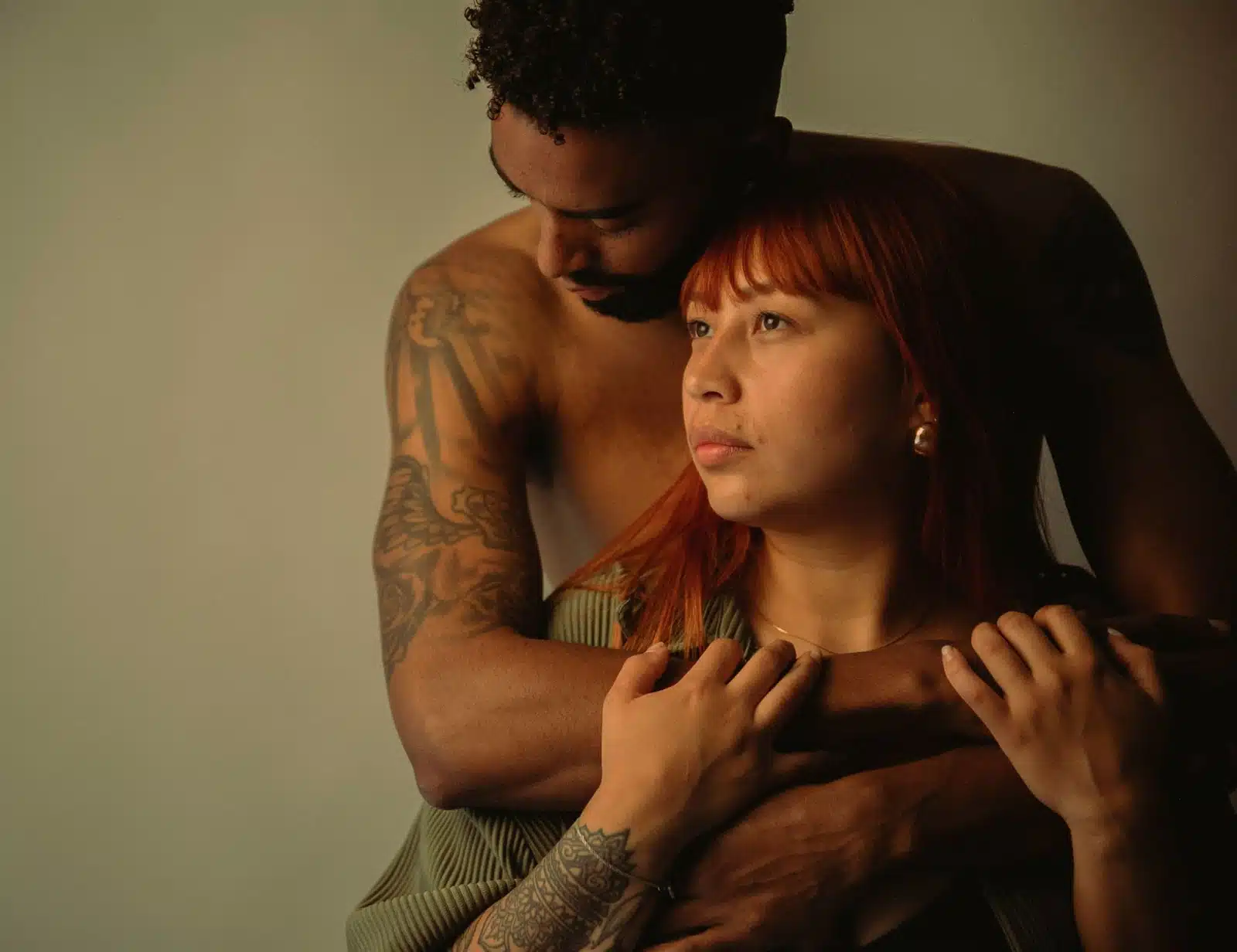 A man hugging a woman from her back.