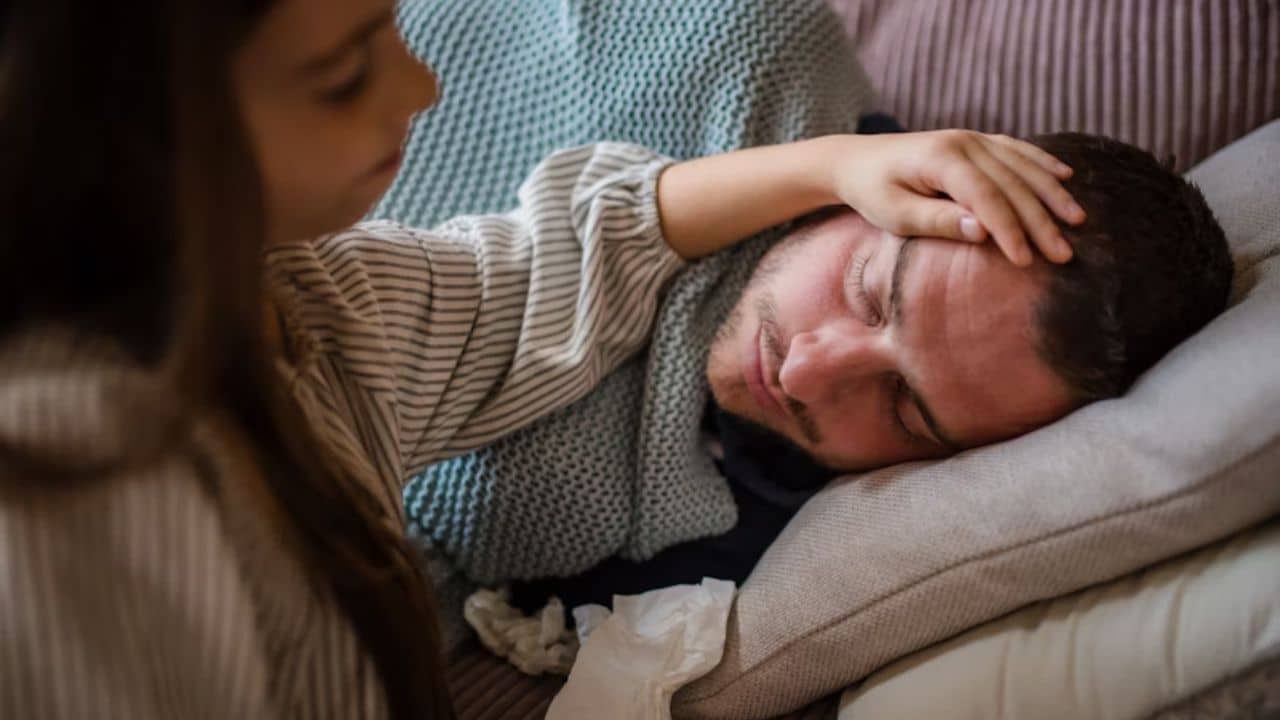 Woman comforting a sick man with  a gentle touch.