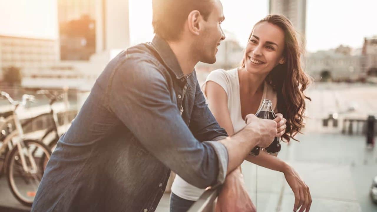 ALT Text: Couple having a vulnerable and honest moment together on a balcony.