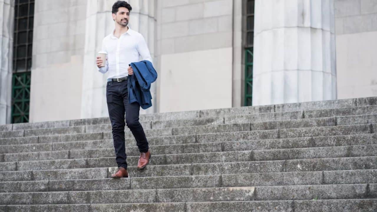 Man walking alone, looking reflective after a breakup or realization.