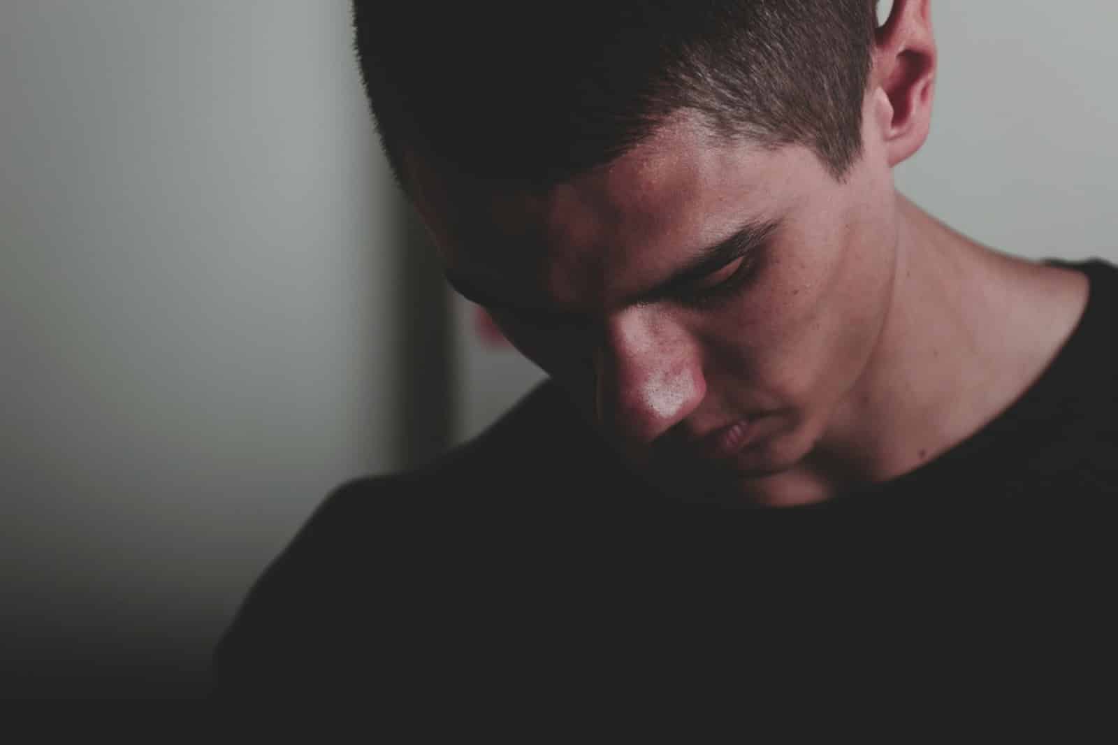 A picture of a man looking down.