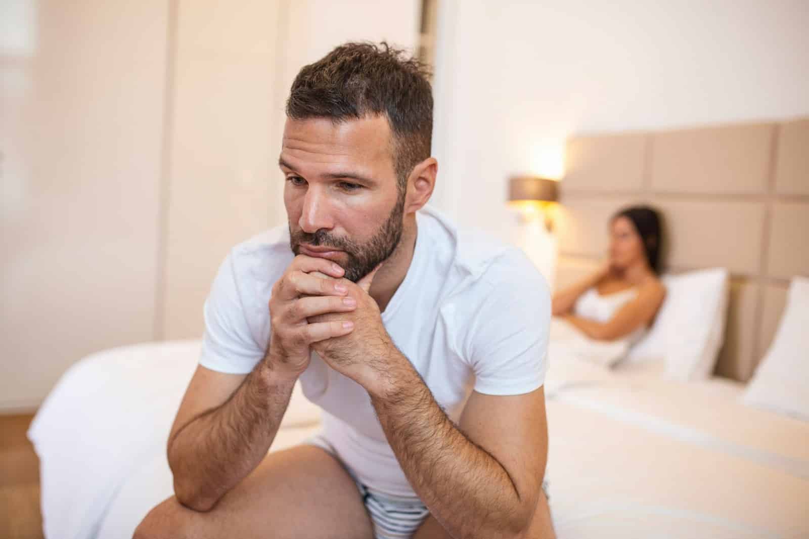 A man sitting away from his girlfriend.