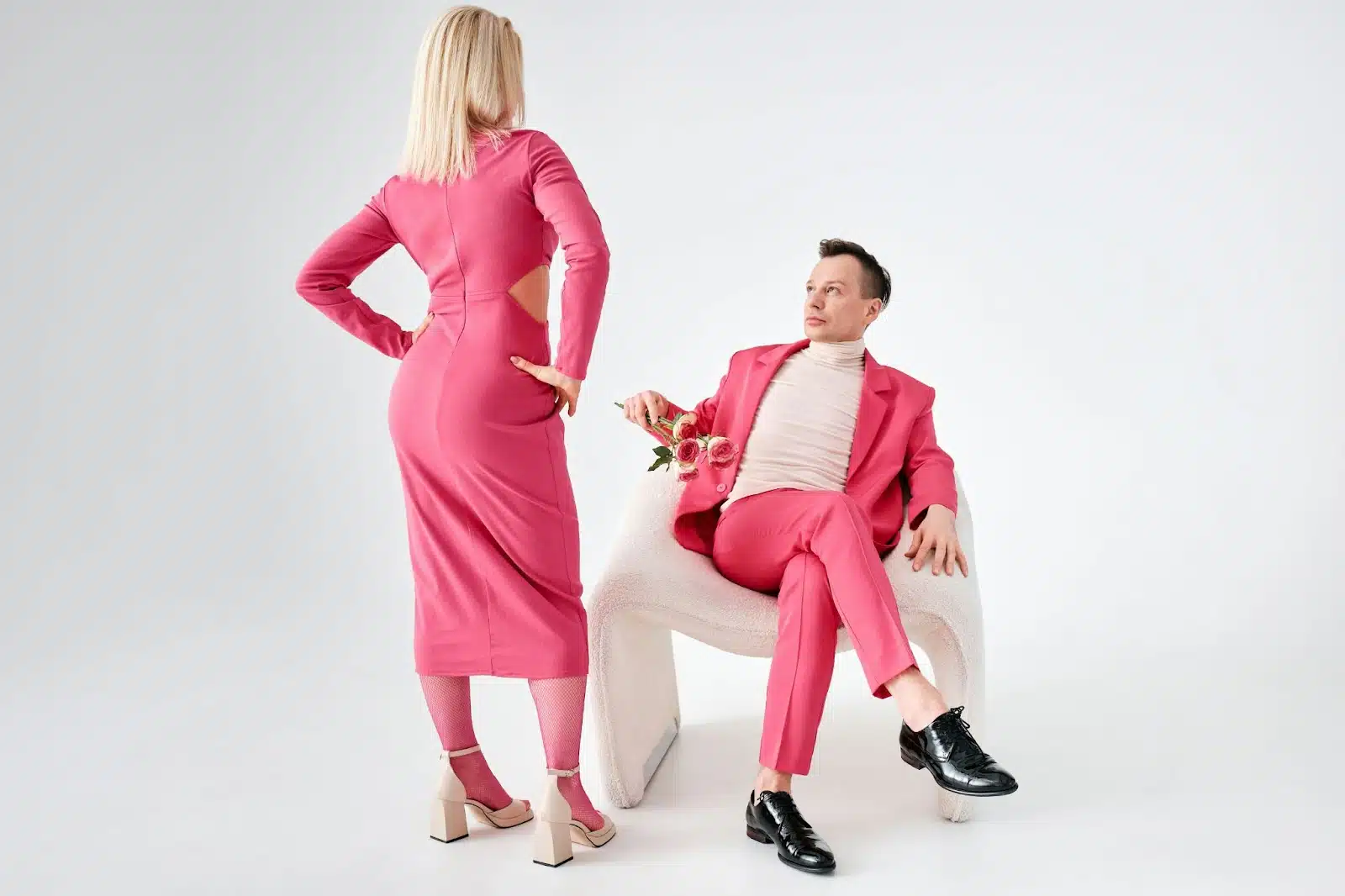  A woman looking at man sitting on the chair.