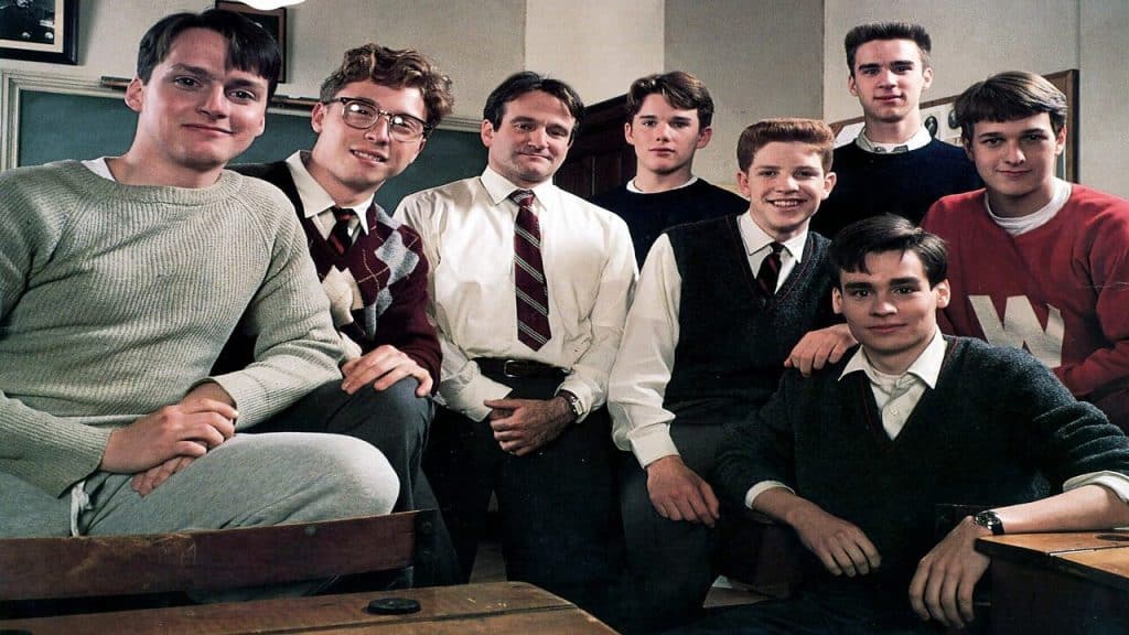 A group of male students and their teacher pose for the camera.