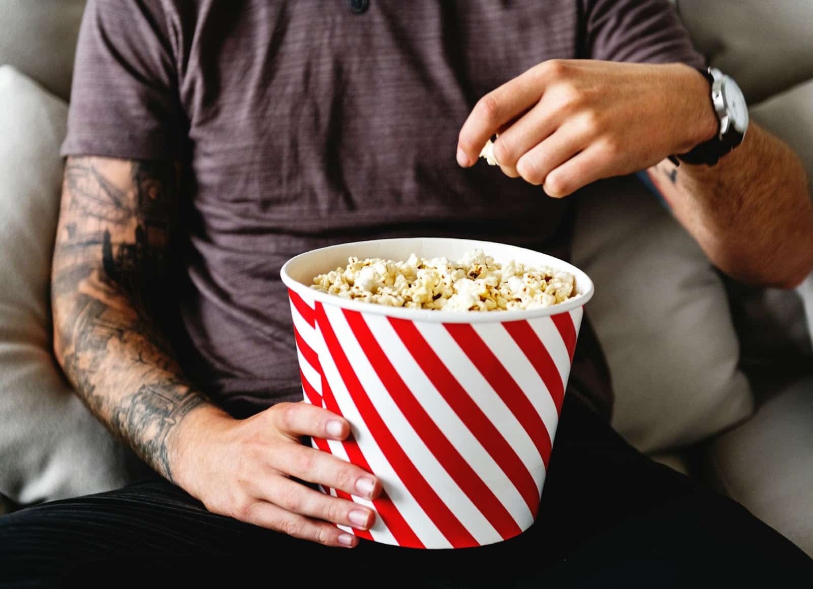 A man holding a popcorn.