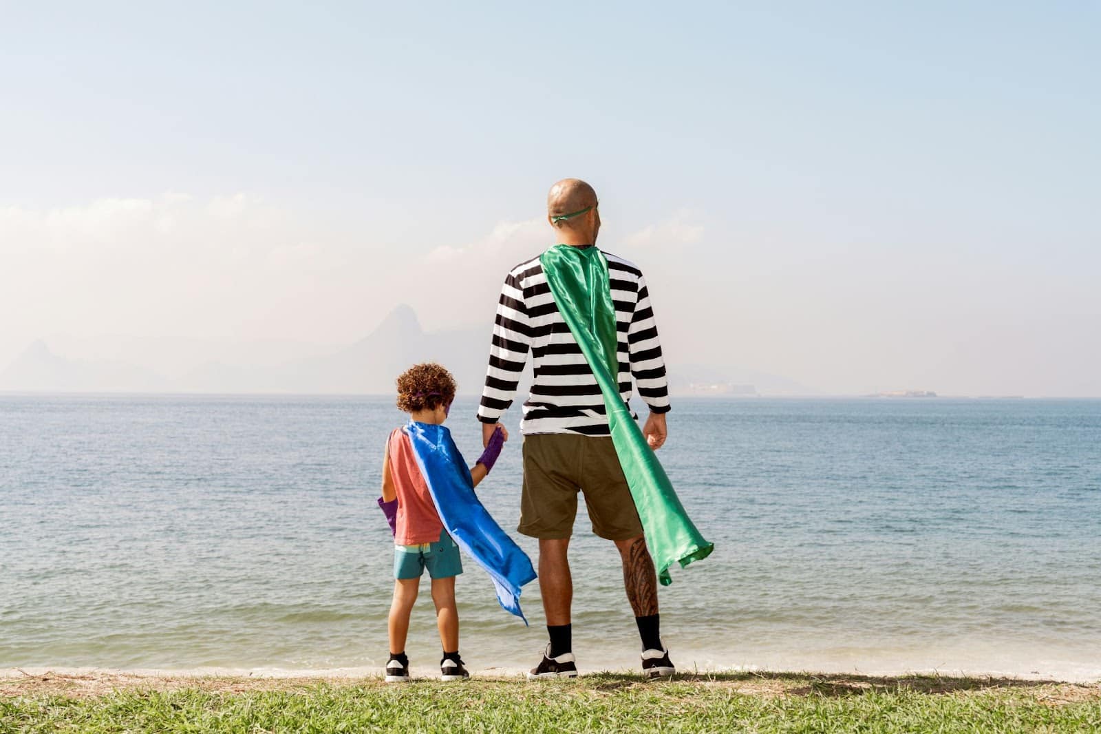A man with his son wearing a costume as a Hero.