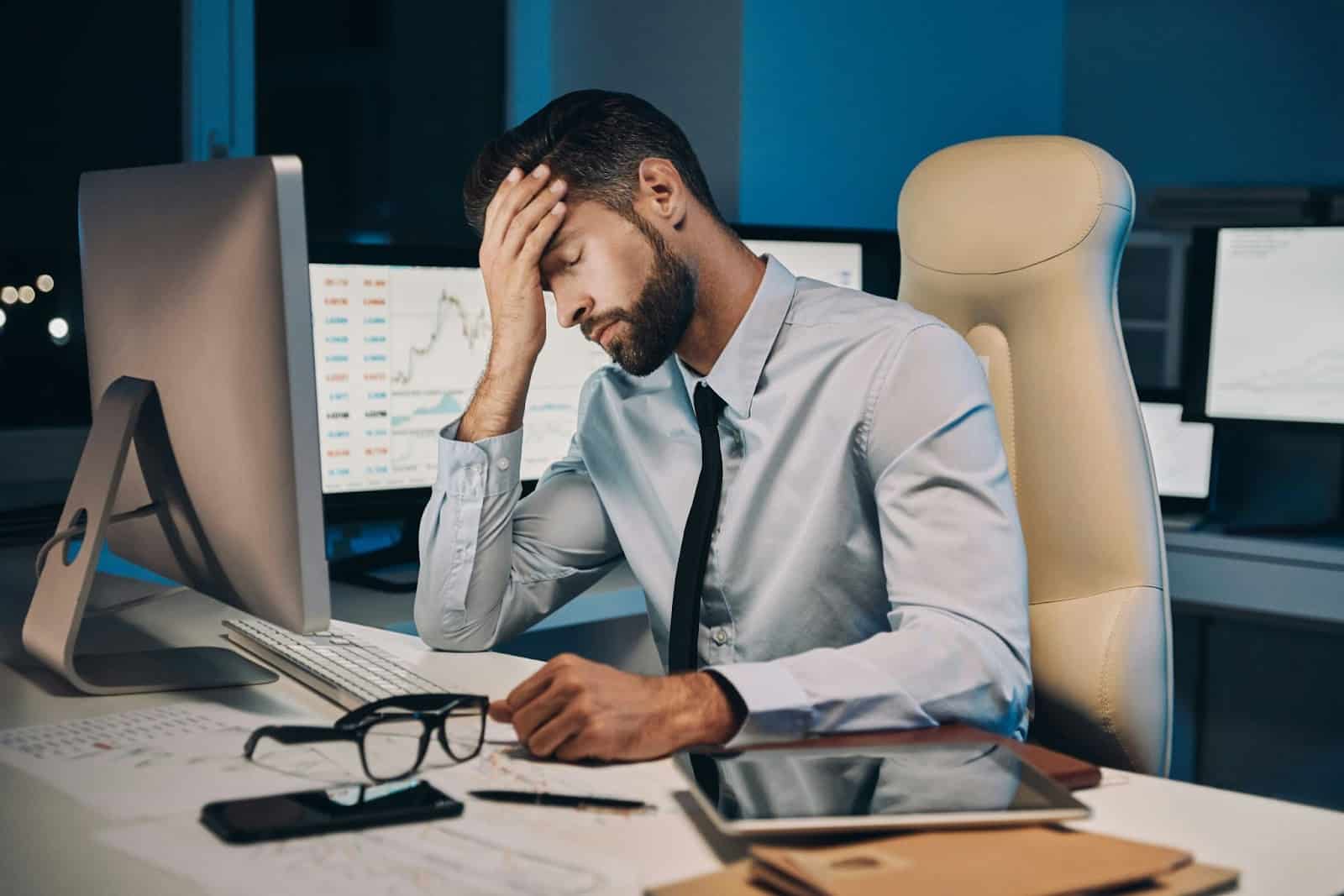 A man looking exhausted while at work.