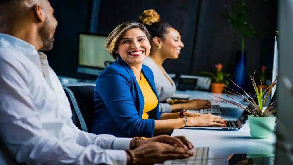 A woman smiling at her colleague.