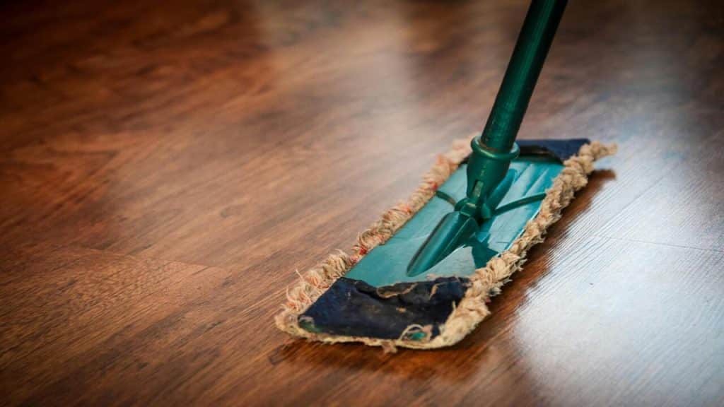 A mop being used on the floor.