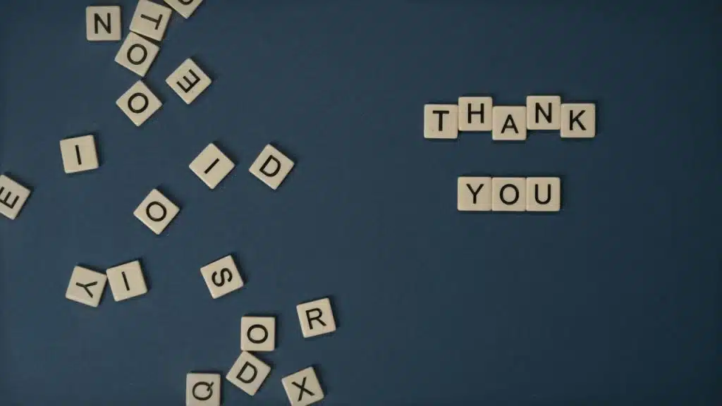 Scrabble tiles spelling out “thank you”.