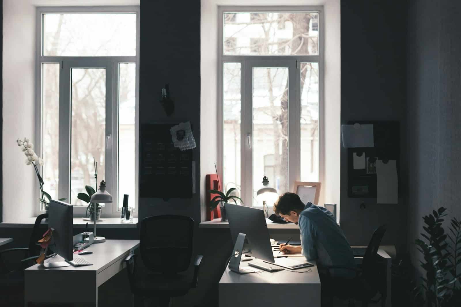 A man working alone on his office.