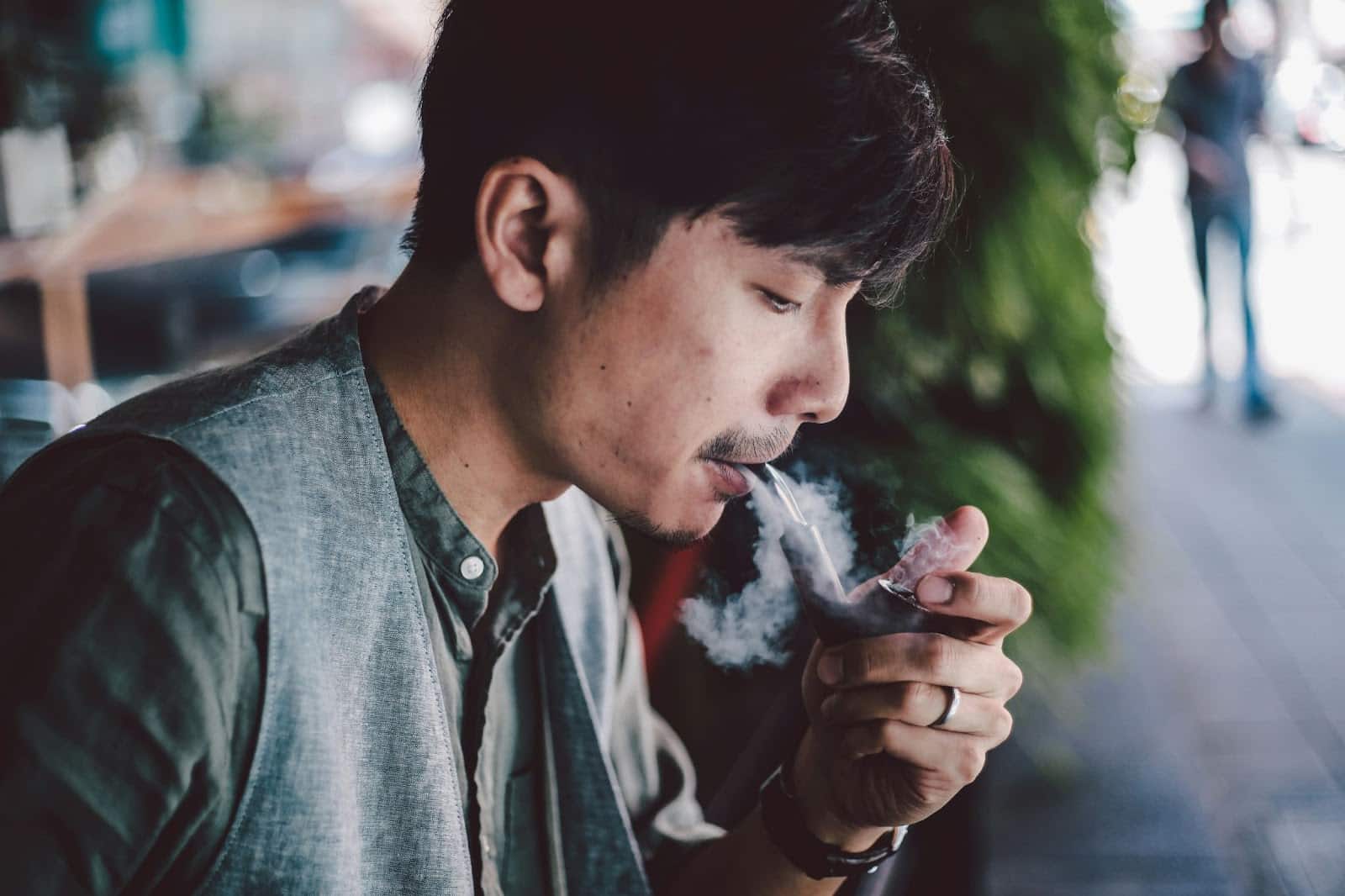 A man smoking outside.