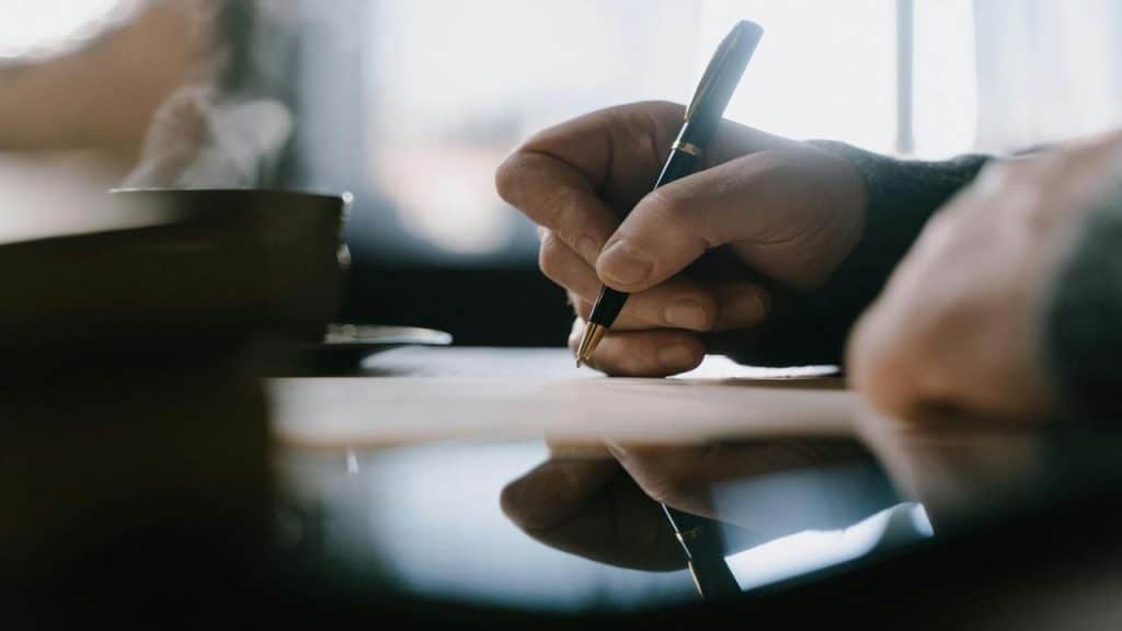 A man writing down his thoughts.