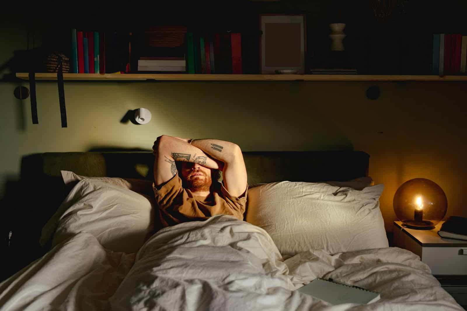 A picture of a man covering his eyes because of brightness.