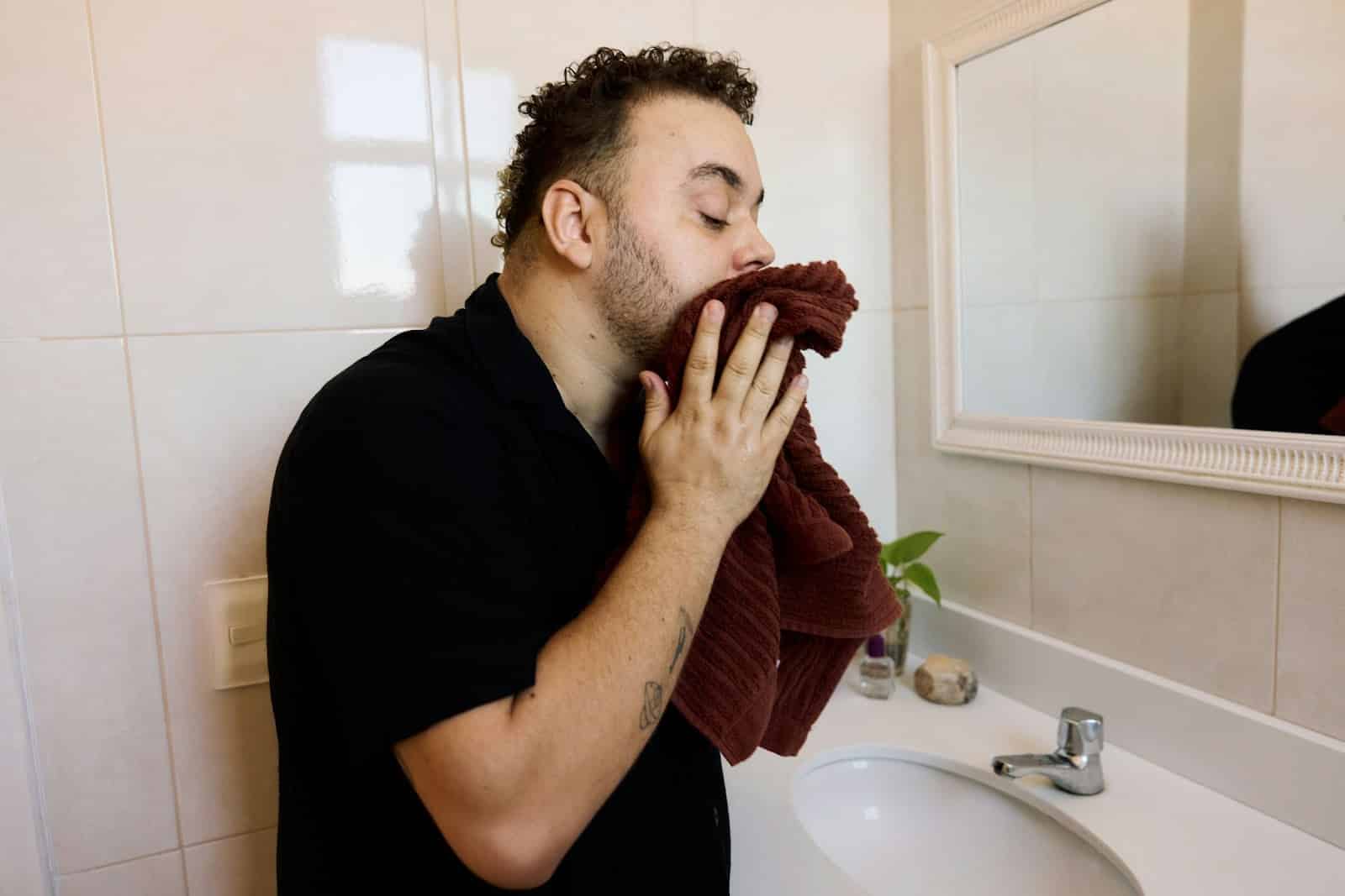 A man wiping his face.