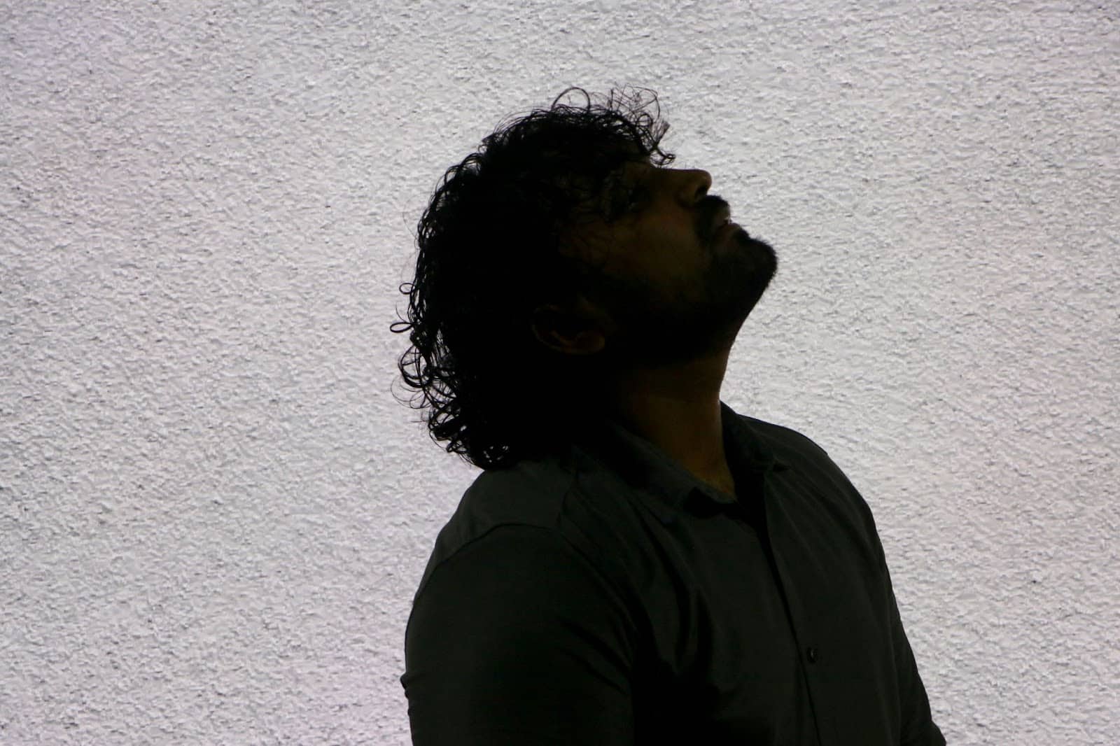 A man breathing looking upwards.