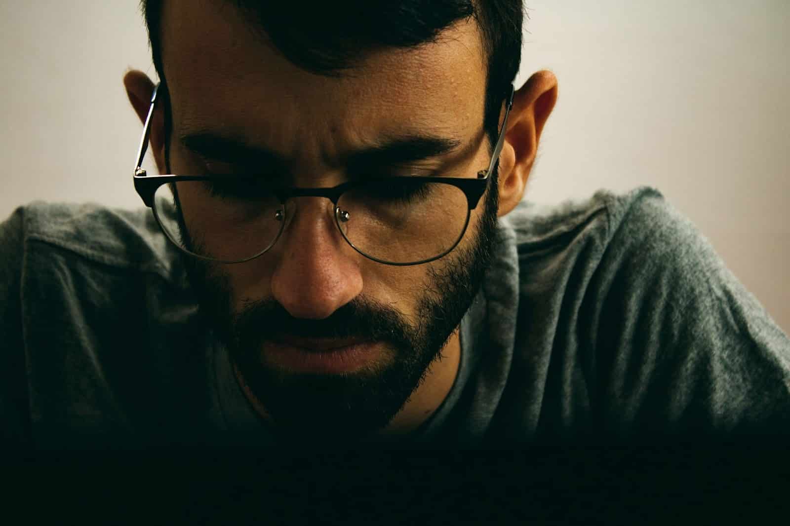 A close-up picture of a man having troubles concentrating.