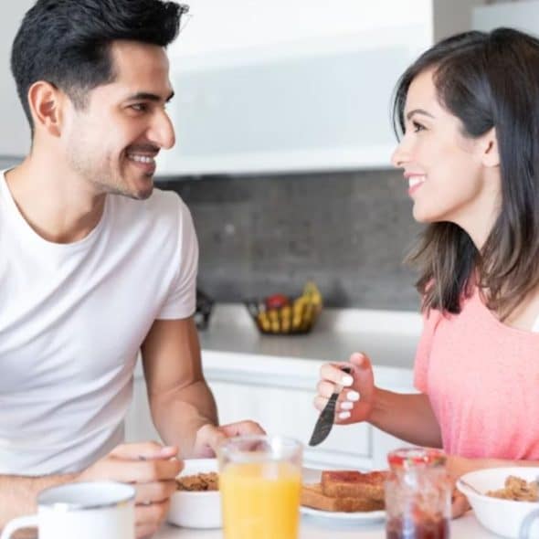Man gazing at his wife with affection during a quiet morning moment