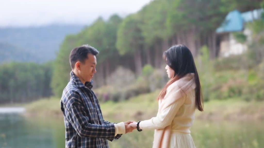 Man apologizing and holding wife’s hand with sincerity