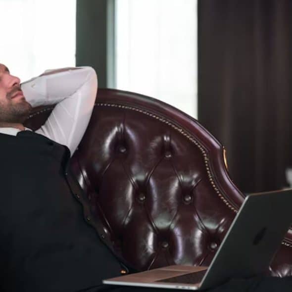 A worn out man leaning on the chair and taking a break