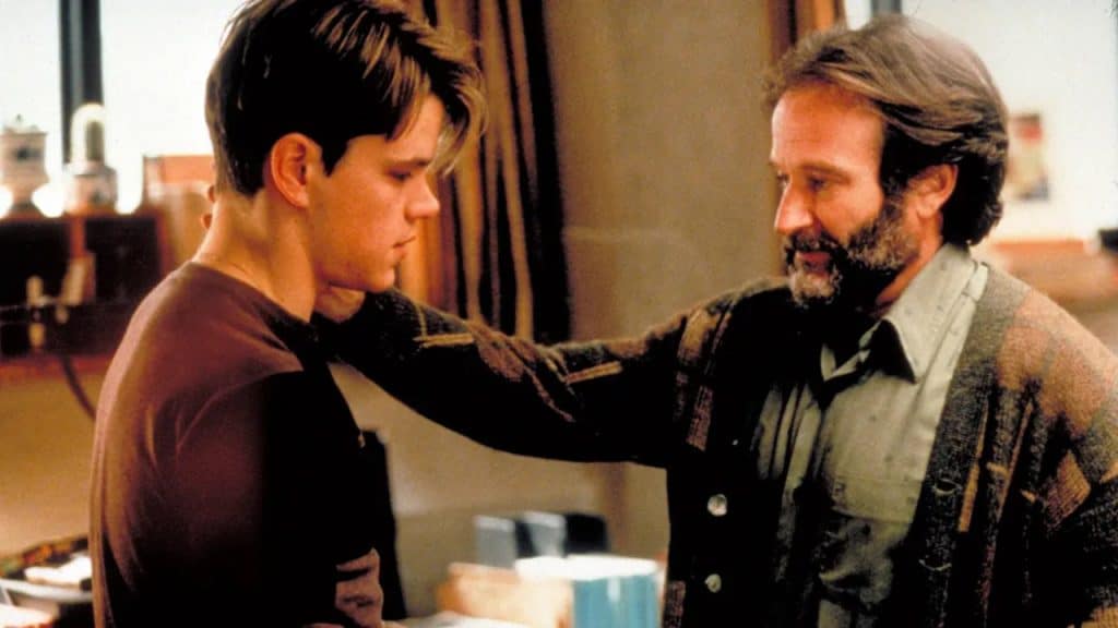 An older man looking at a younger man with encouragement.