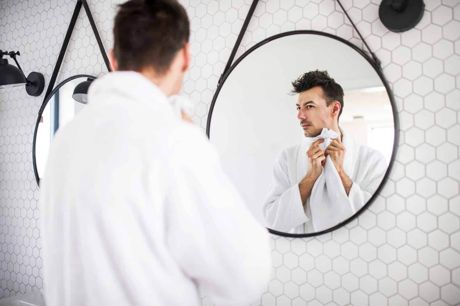 A man looking at the mirror.