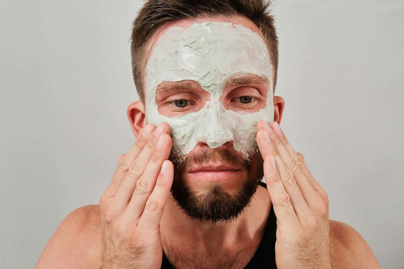 A man exfoliating skin.