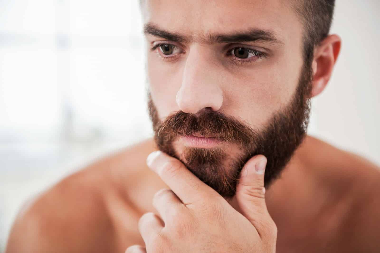 A close-up picture of a man with a beard.