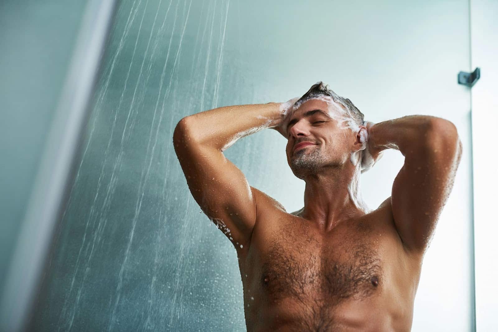 A man shampooing his hair.