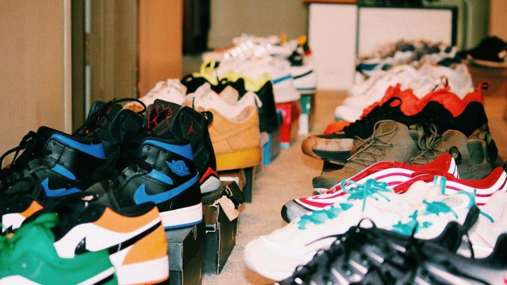 A row of colorful sneakers displayed on shoeboxes.