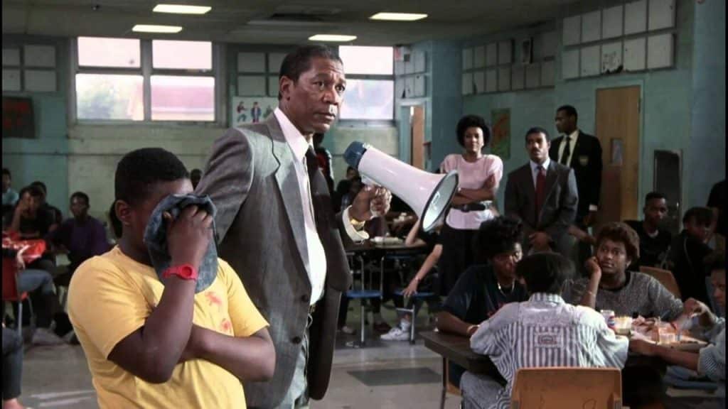 A teacher holding a megaphone in the cafeteria.