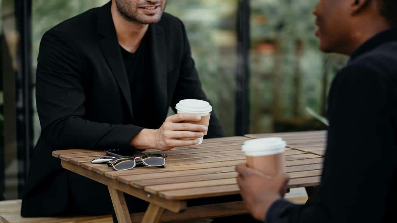 Two male friends having coffee.