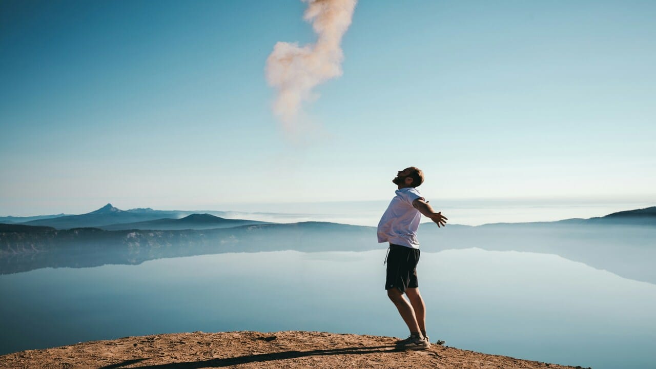 A man looking free near a body of water.