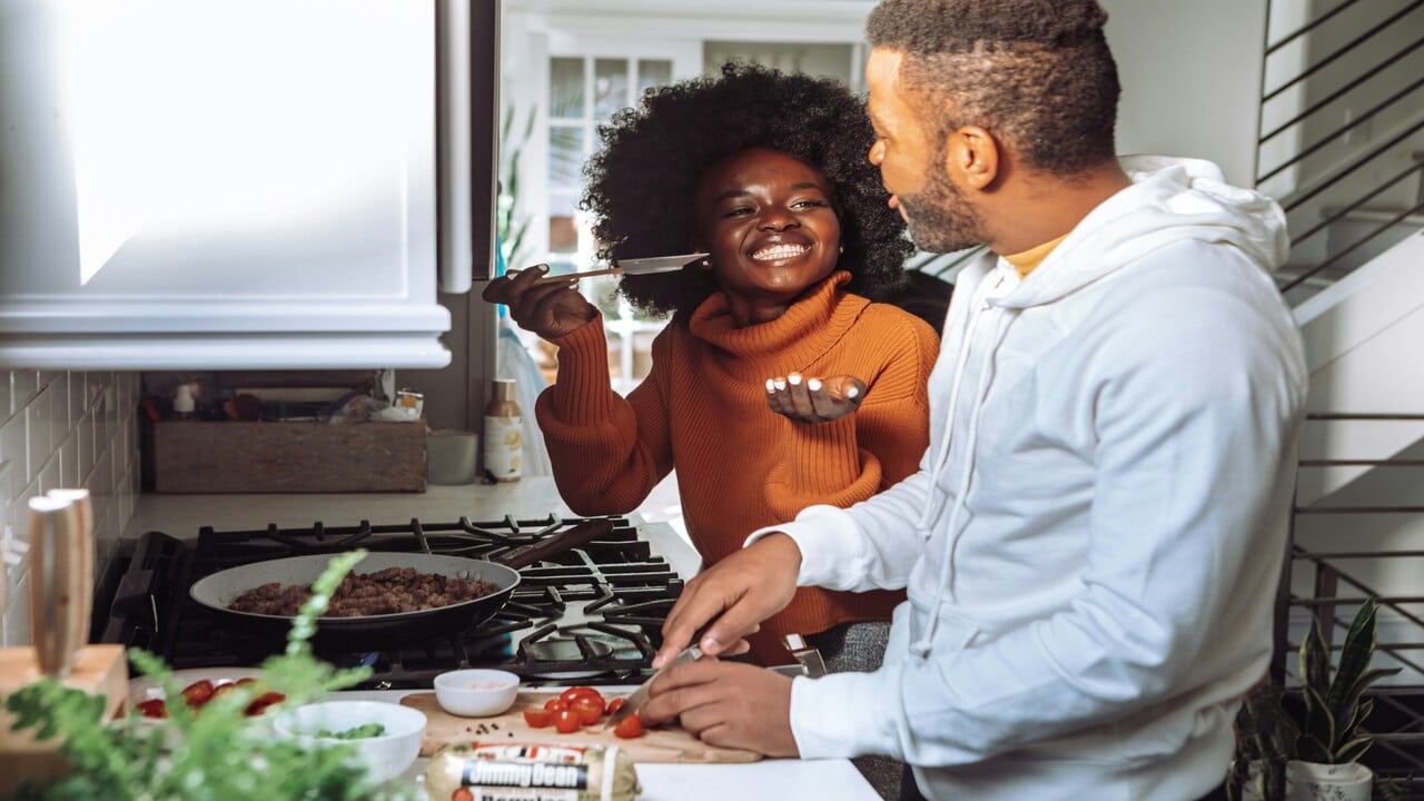 A couple cooking in the kitchen.