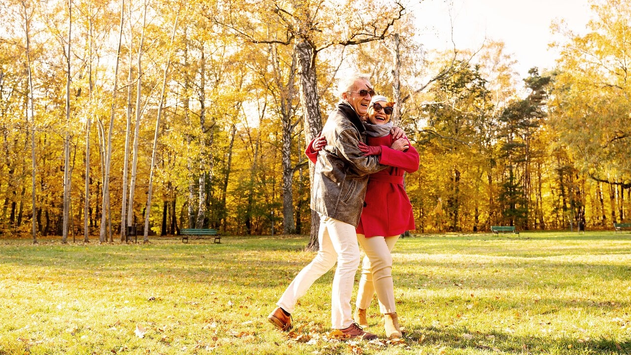 An elderly couple looking happy.