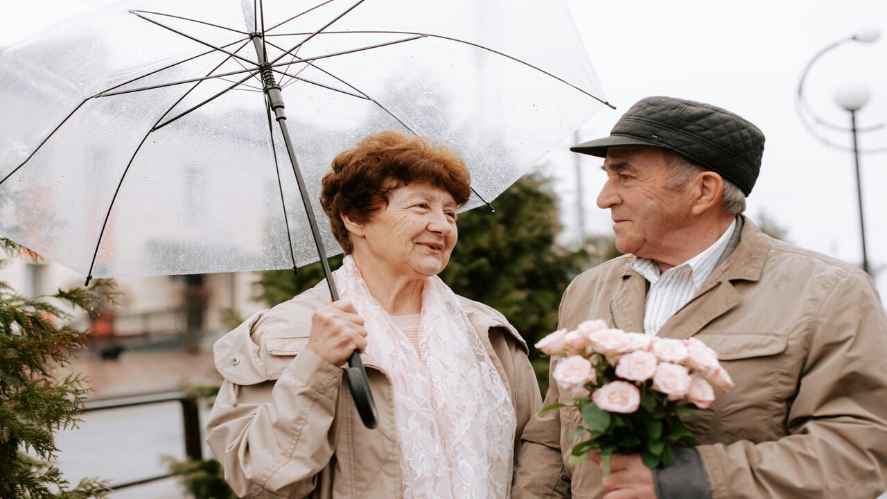 An elderly couple looking happy together.