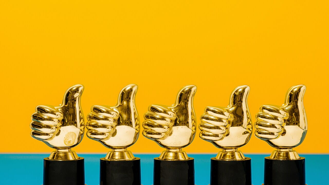 Golden hands giving a thumbs up.