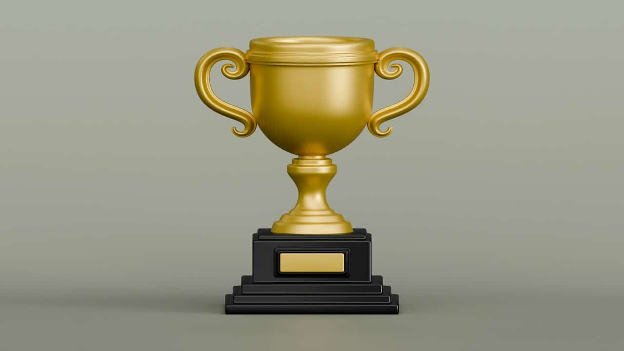 A golden trophy on a green background.