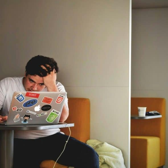 A man looking stressed at work.