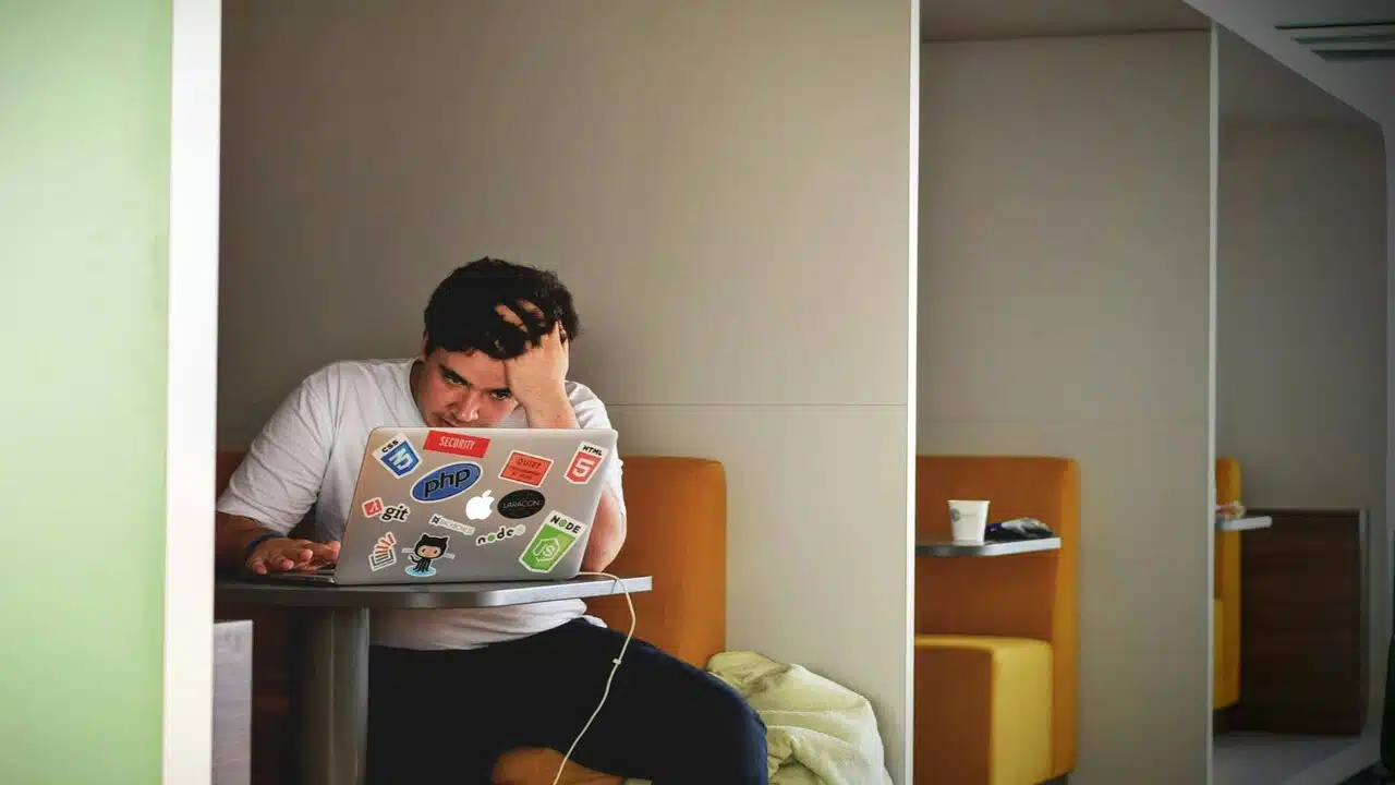 A man looking stressed at work.