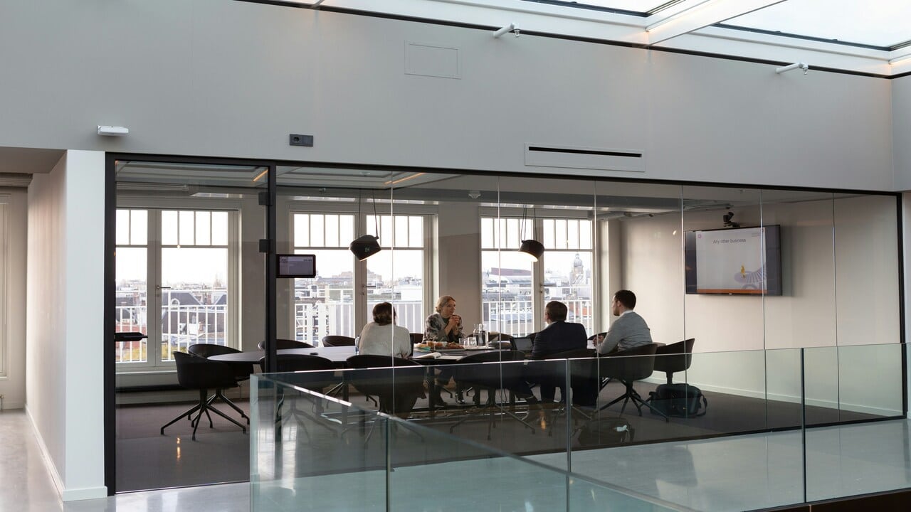 A group  of people at a meeting.
