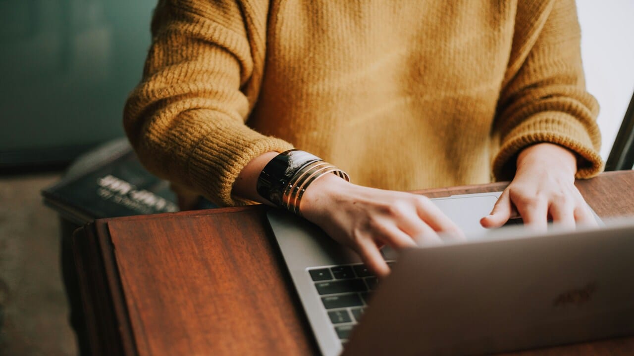 A person using a laptop computer.