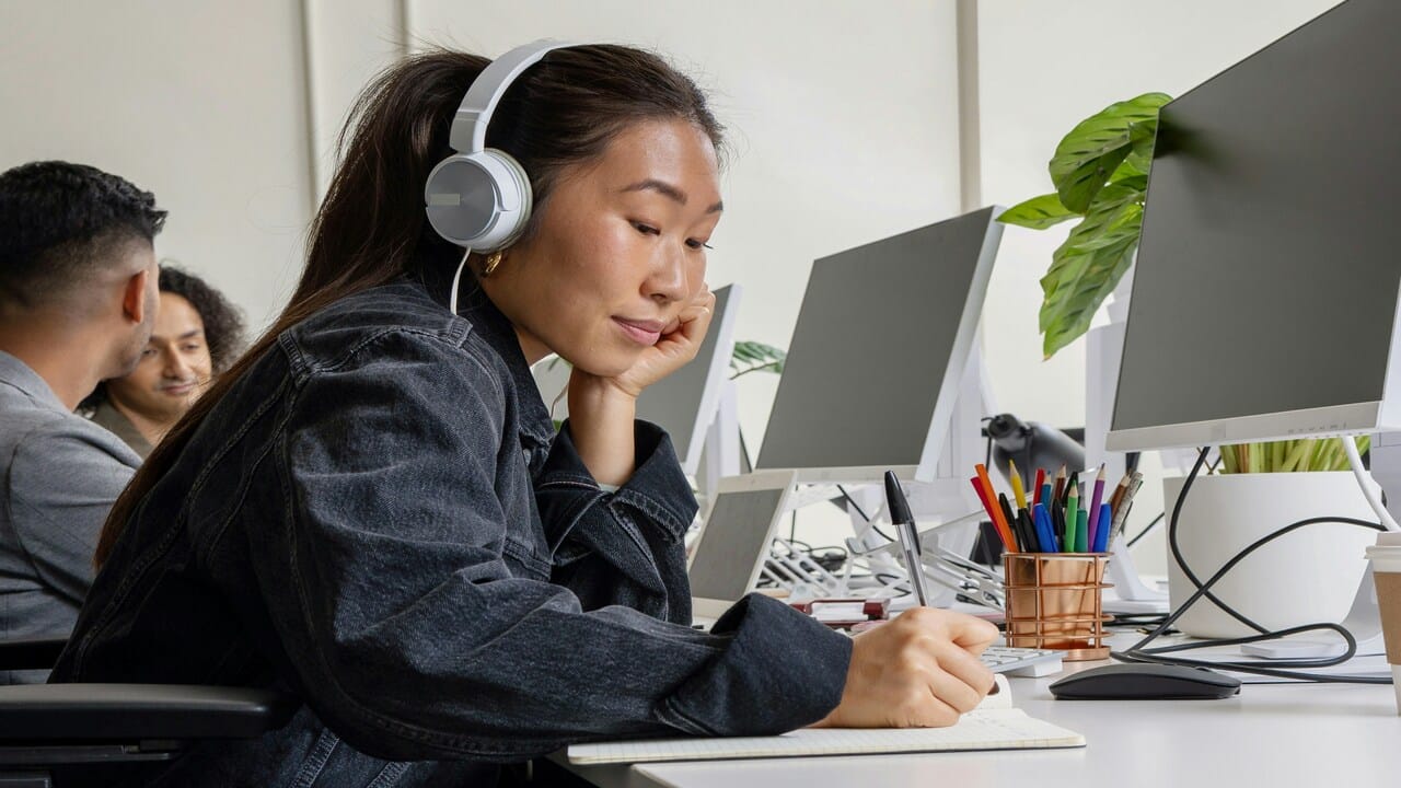 A woman working quietly with headphones on.