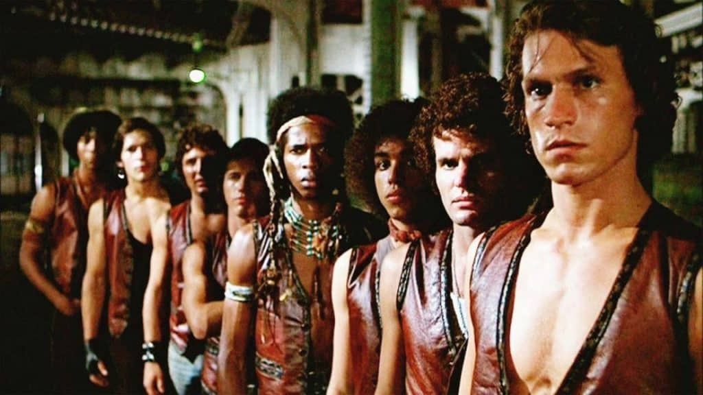 A group of men wearing the same outfit looking at the same direction.