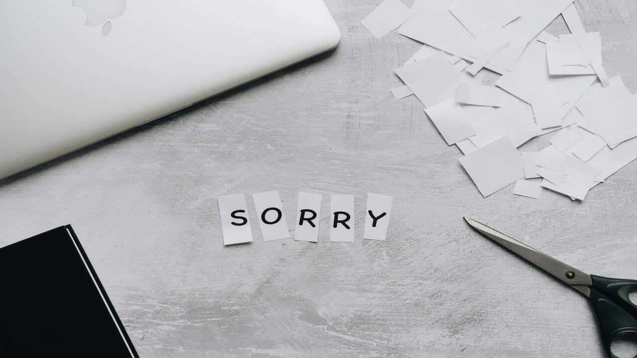Pieces of paper spelling out the word “sorry”.