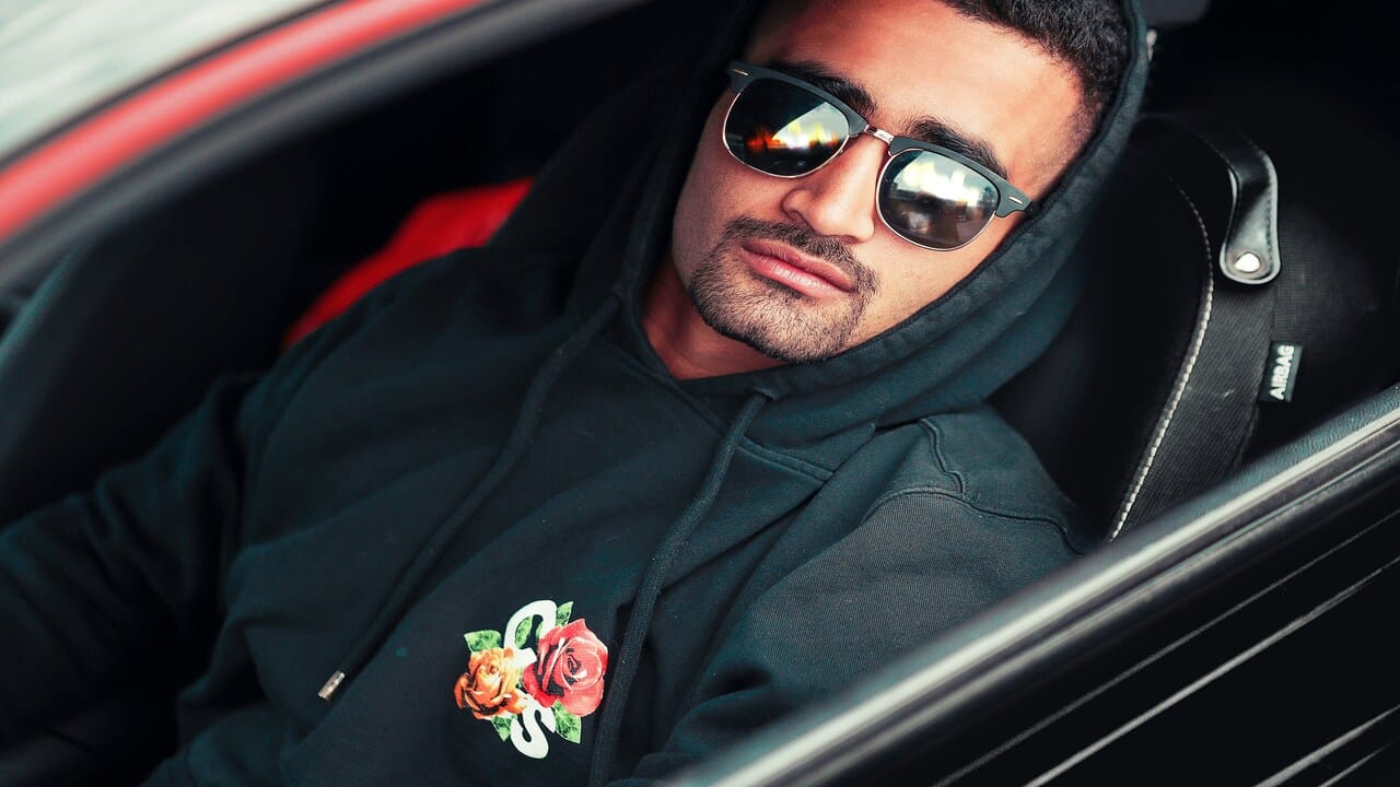 A man sitting inside his car.