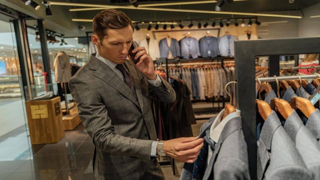 A man in a suit shopping at a department store.